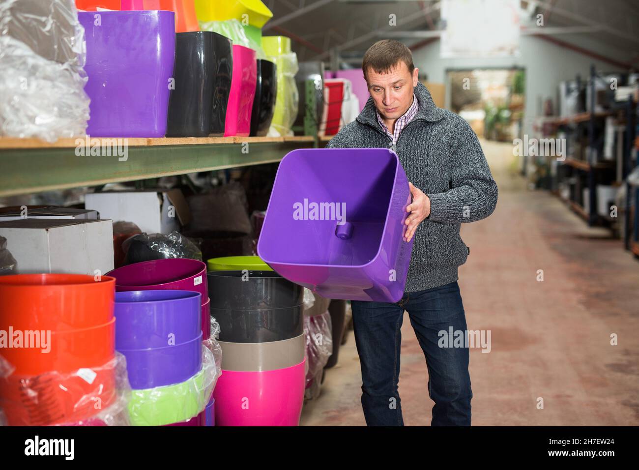 Pot Owner Greenhouse owner choosing plant pots Stock Photo - Alamy