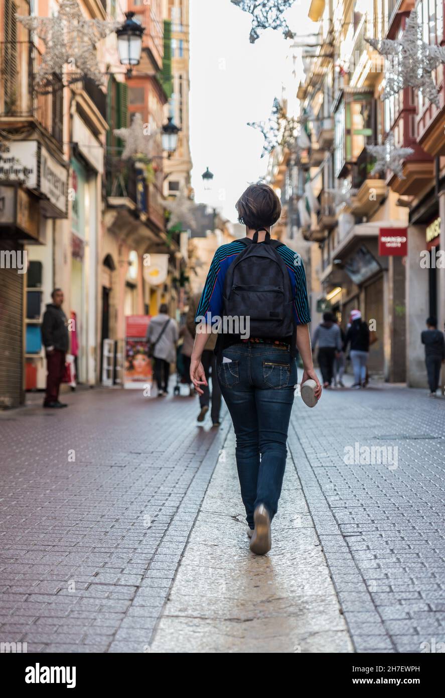 Female tourist walking through the streets of Old Town in Palma de Mallorca Stock Photo