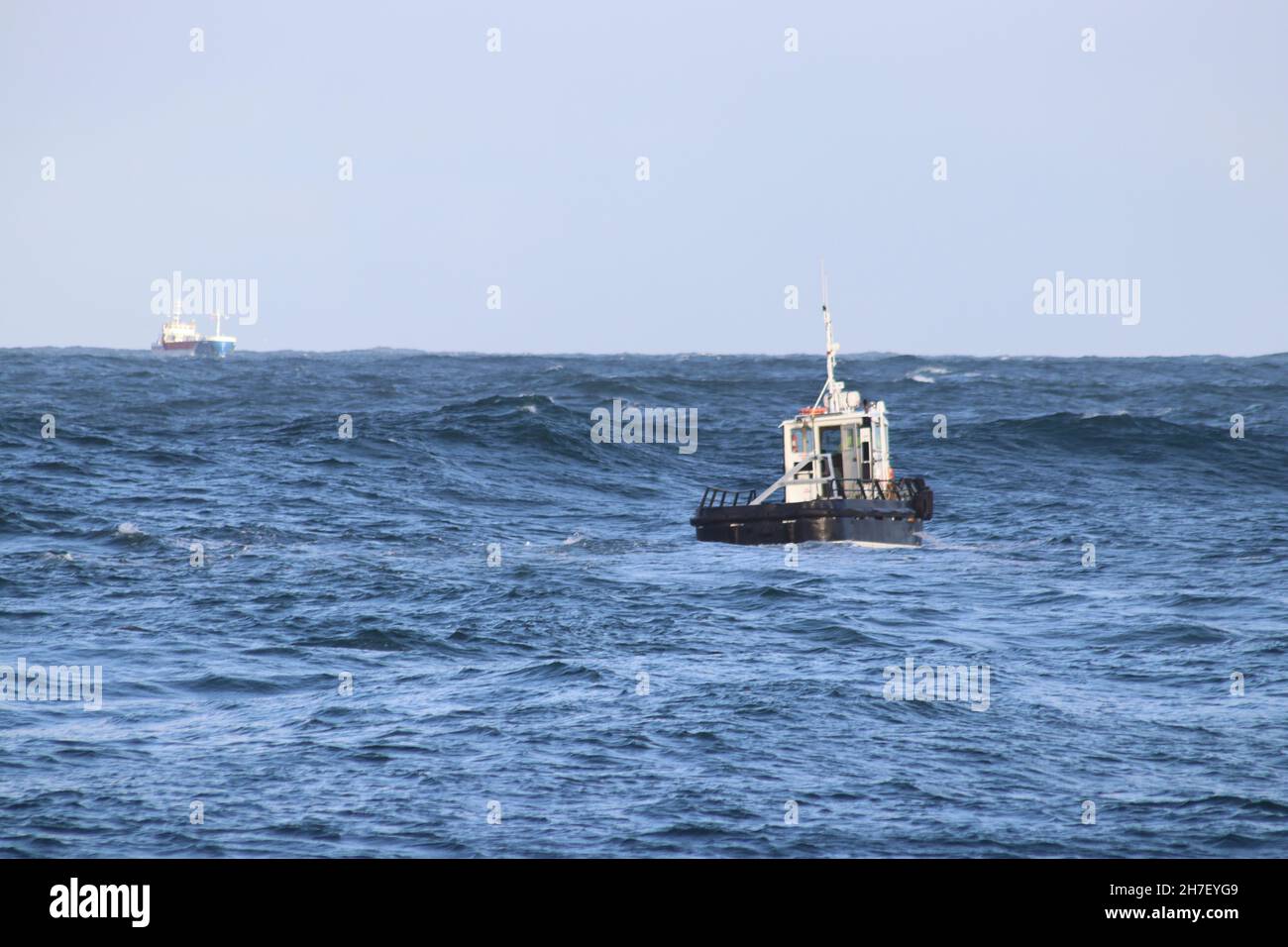 Pilot boat going out to lead ship into harbour Stock Photo
