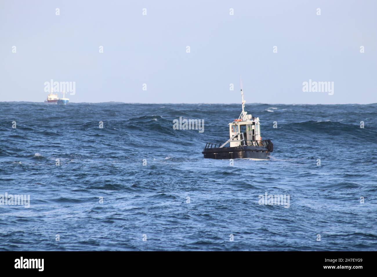 Pilot boat going out to lead ship into harbour Stock Photo - Alamy