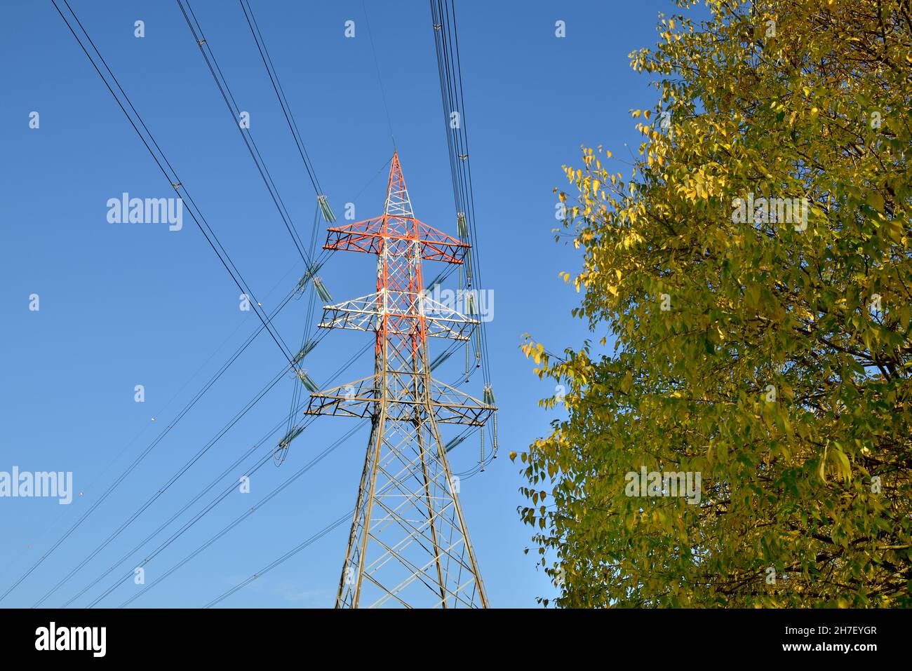 Red and white painted transmission tower Stock Photo