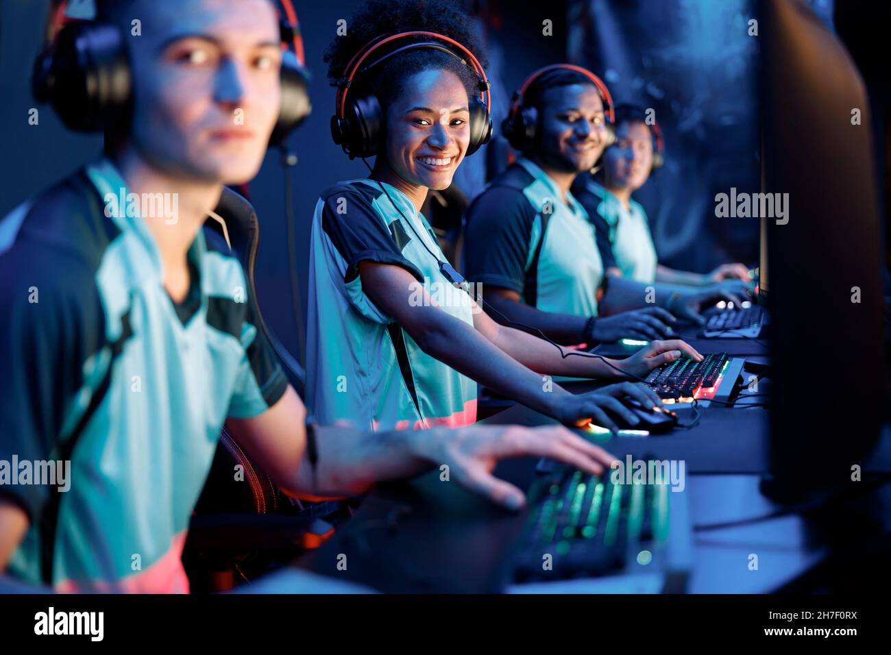 Young professional esports players playing games in internet cafe Stock Photo