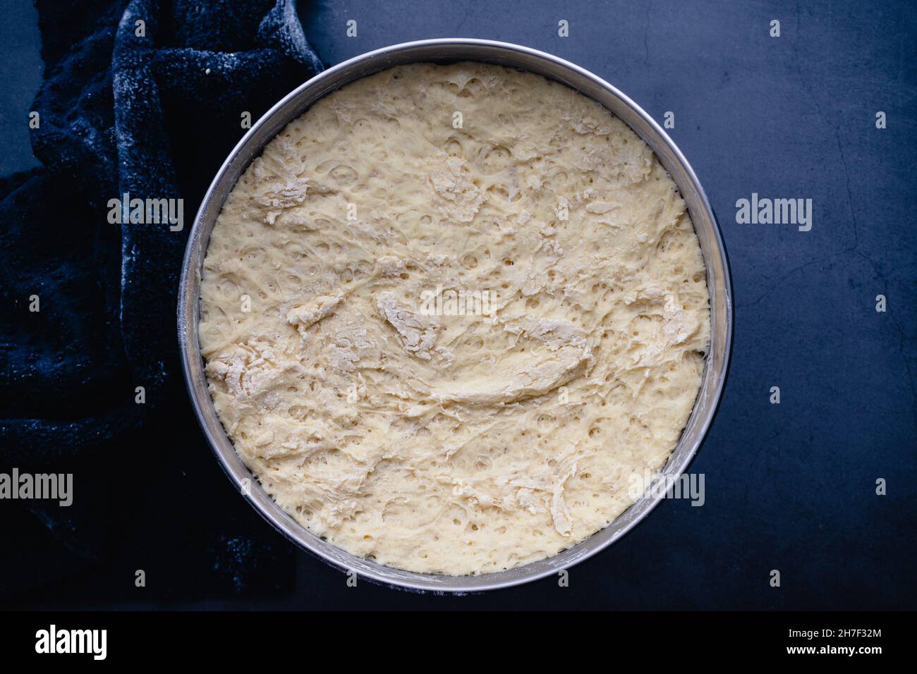 Uncooked Bread Dough in a Mixing Bowl: Rising French bread baguette dough in a stainless steel metal mixing bowl Stock Photo