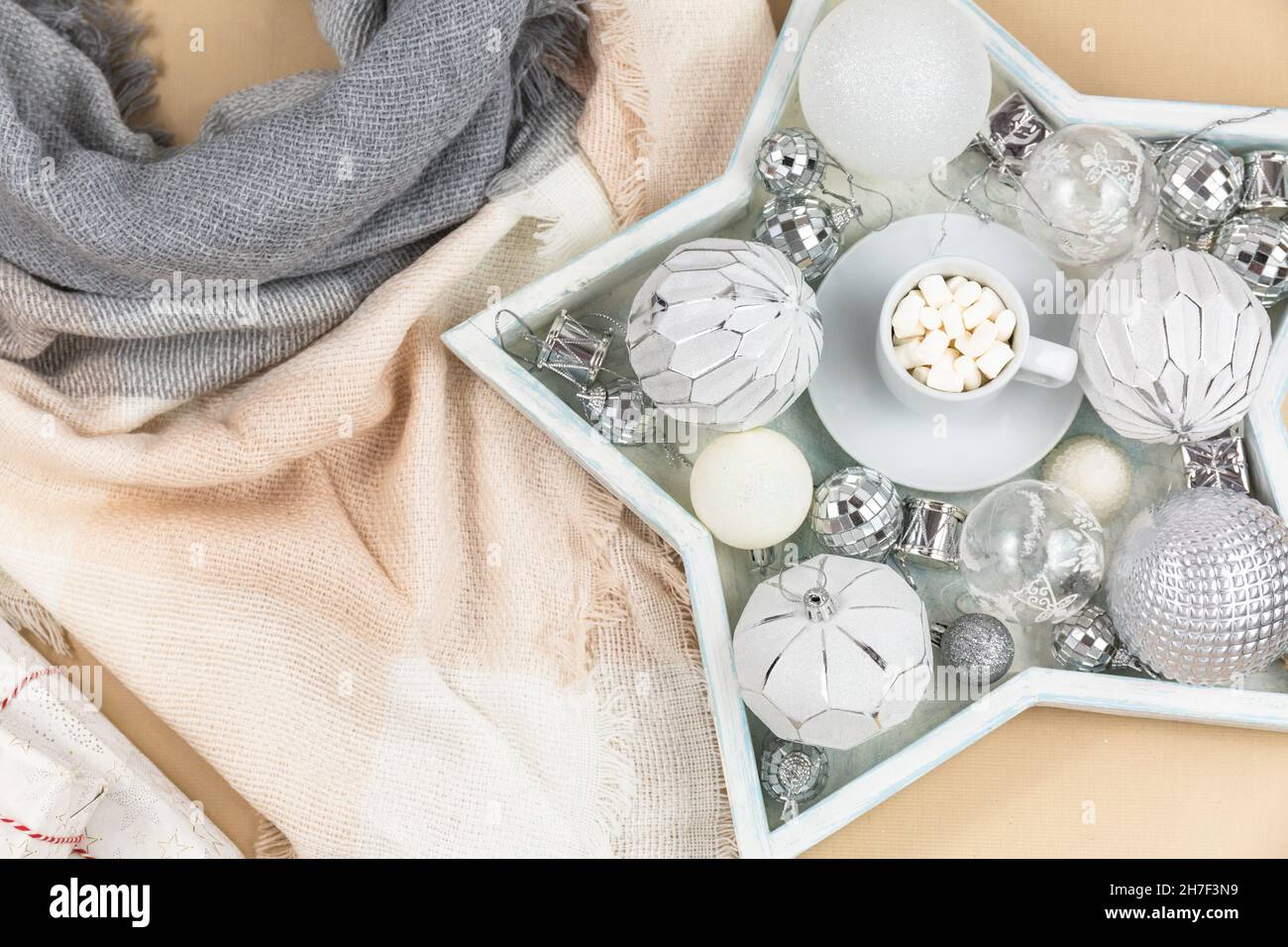 A cup of coffee with marshmallows on white tray and garlands, led lights. Christmas still life Stock Photo