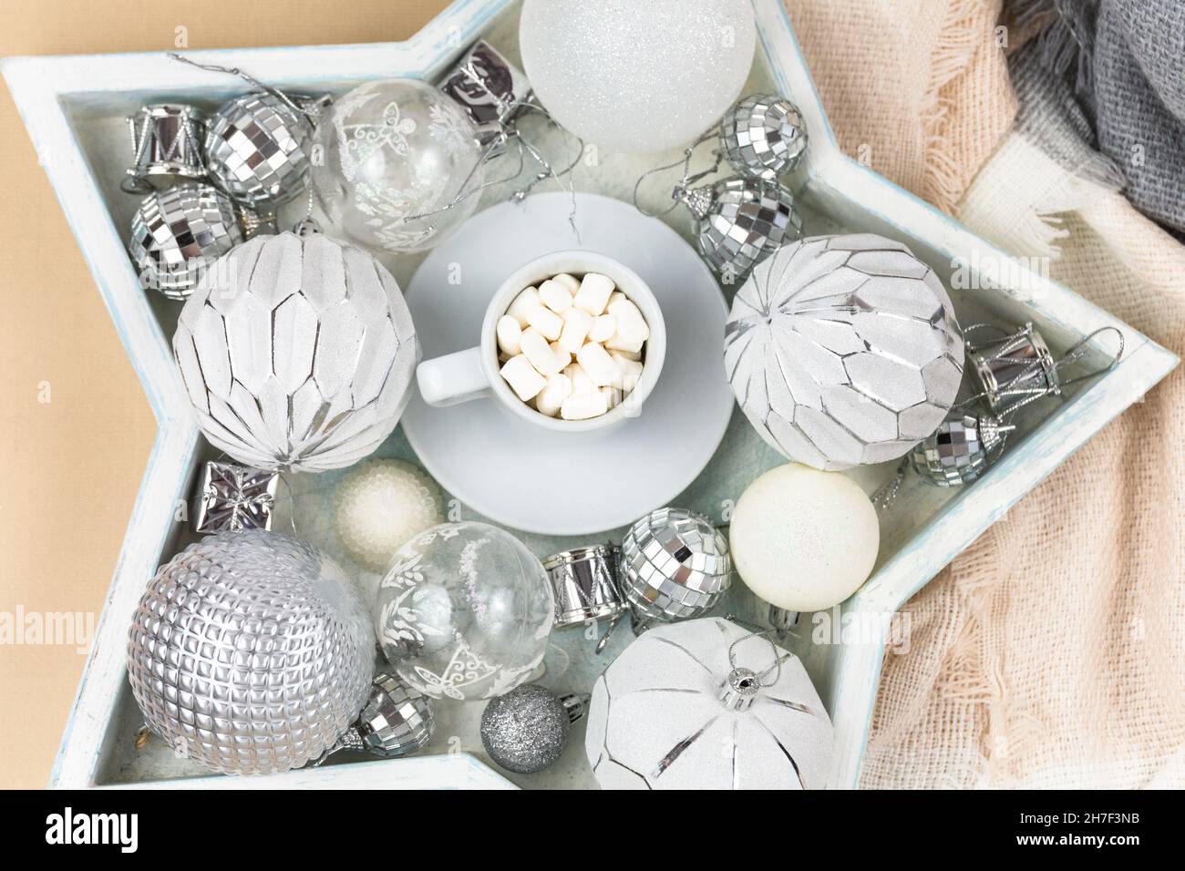 A cup of coffee with marshmallows on white tray and garlands, led lights. Christmas still life Stock Photo