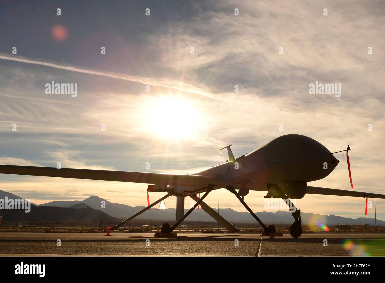 Indian Springs, United States of America. 08 December, 2016. A U.S. Air Force MQ-1 Predator unmanned aerial vehicle is silhouetted by the setting sun on the ground at Creech Air Force Base, December 8, 2016 near Las Vegas, Nevada.  Credit: SrA Christian Clausen/US Air Force Photo/Alamy Live News Stock Photo