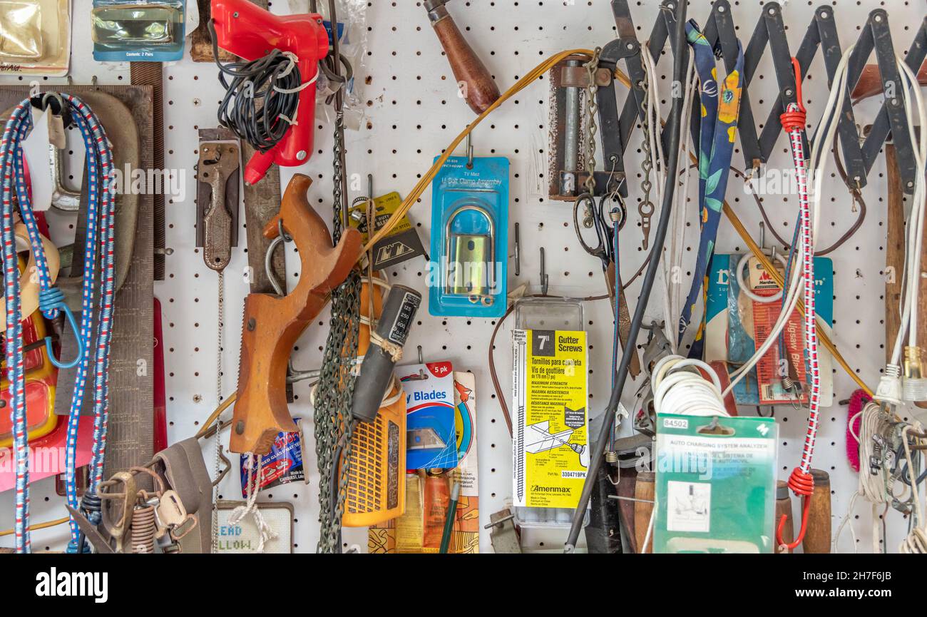 Detail image of a peg board full of tools and random objects Stock Photo