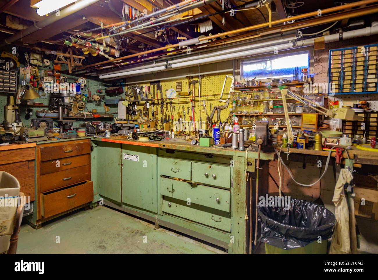 Old basement work shop filled with tools and objects Stock Photo