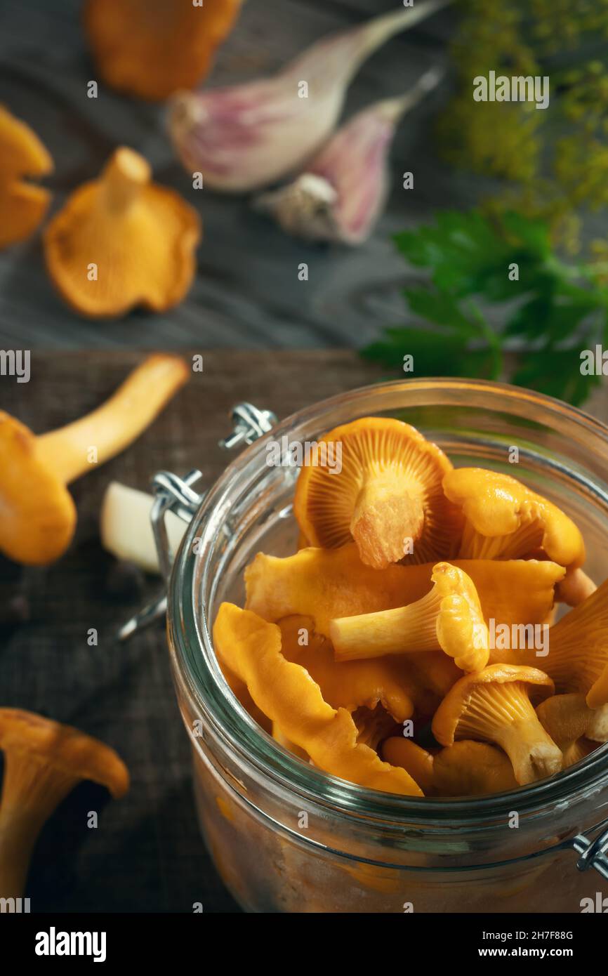 Preserving chanterelle mushrooms in a jar with spices and herbs