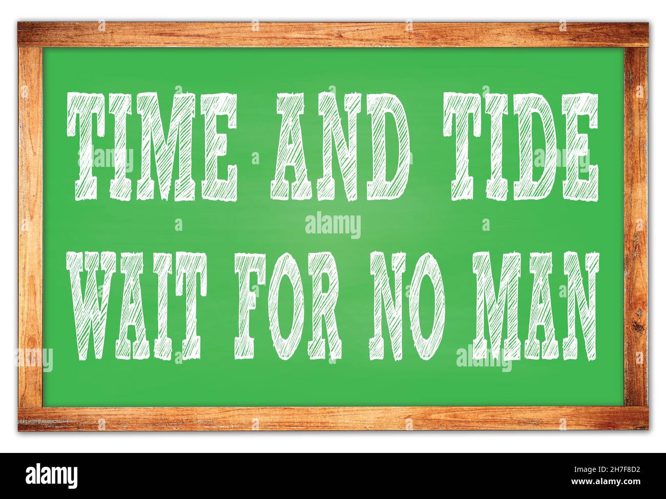 TIME AND TIDE WAIT FOR NO MAN written on green wooden frame school blackboard Stock Photo