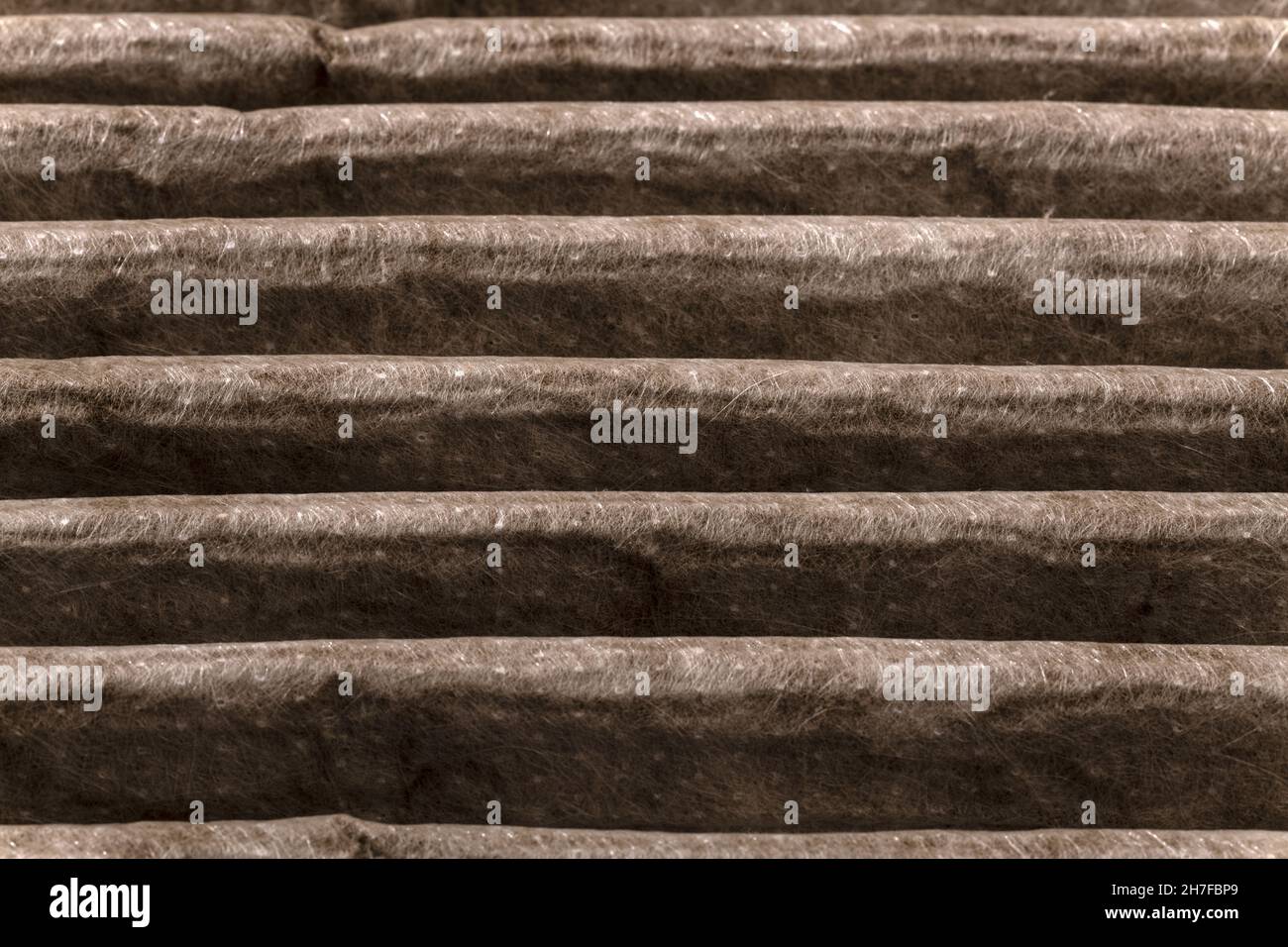 Close up of HVAC home air filter showing the dirt and particle cause
