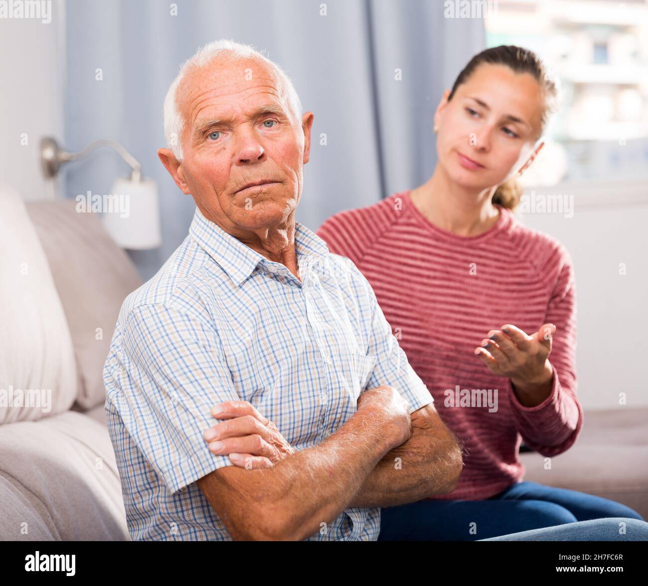 Portrait of upset senior man and daughter quarrelling at home Stock ...