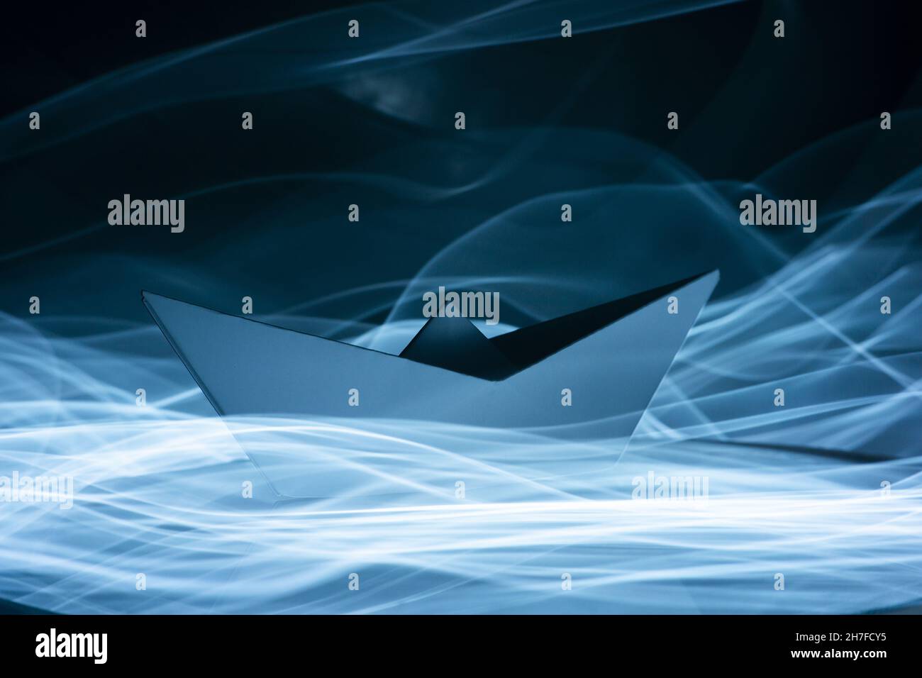 Digital illustration of a paper boat on blue waves Stock Photo - Alamy