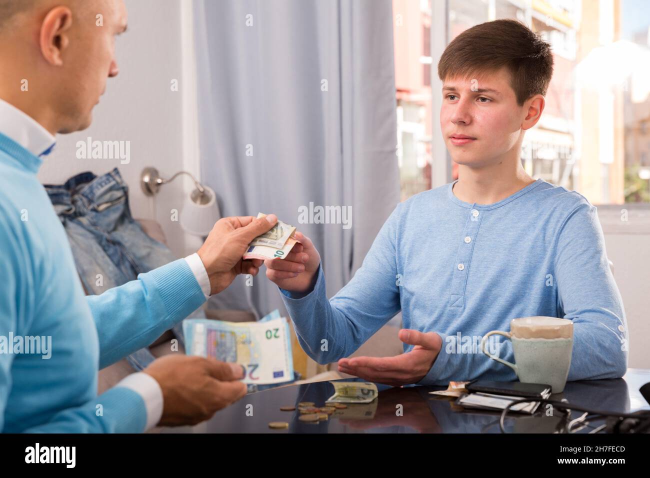 Adult son asking father for money hi-res stock photography and images ...