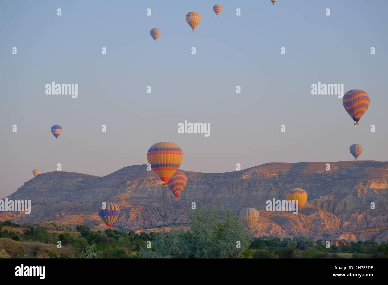 magnificent tourist center of Cappadocia - balloon flight, flying early in the morning just after sun rises by hot air balloons Stock Photo