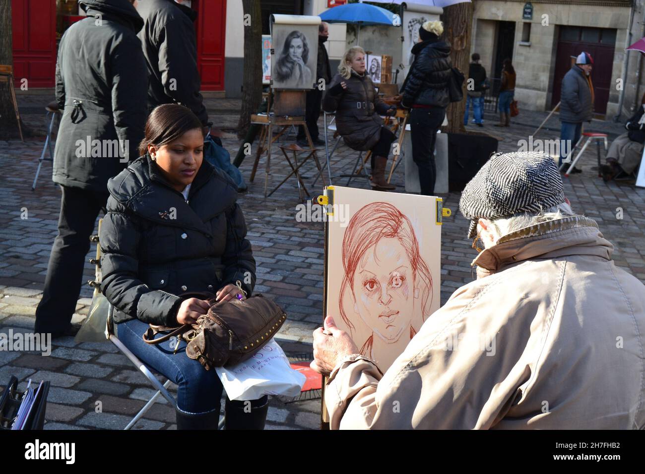 20.02.2012. Paris. France. Street arts of painting in painters hill in paris. An artist making a picture of mid mature of a man. Stock Photo