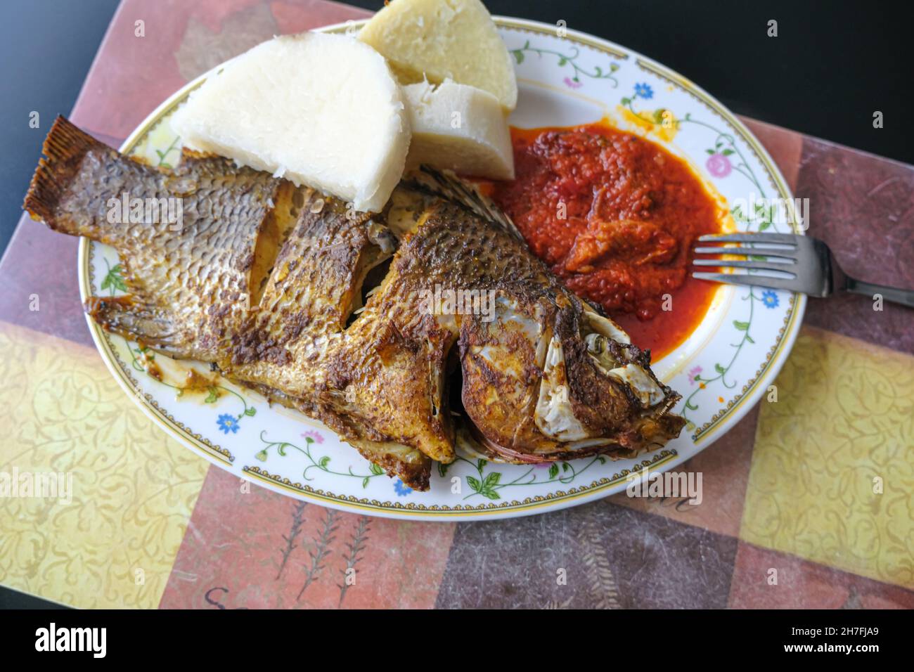 Nigerian boiled yam served with Grilled fish and tomato pepper sauce