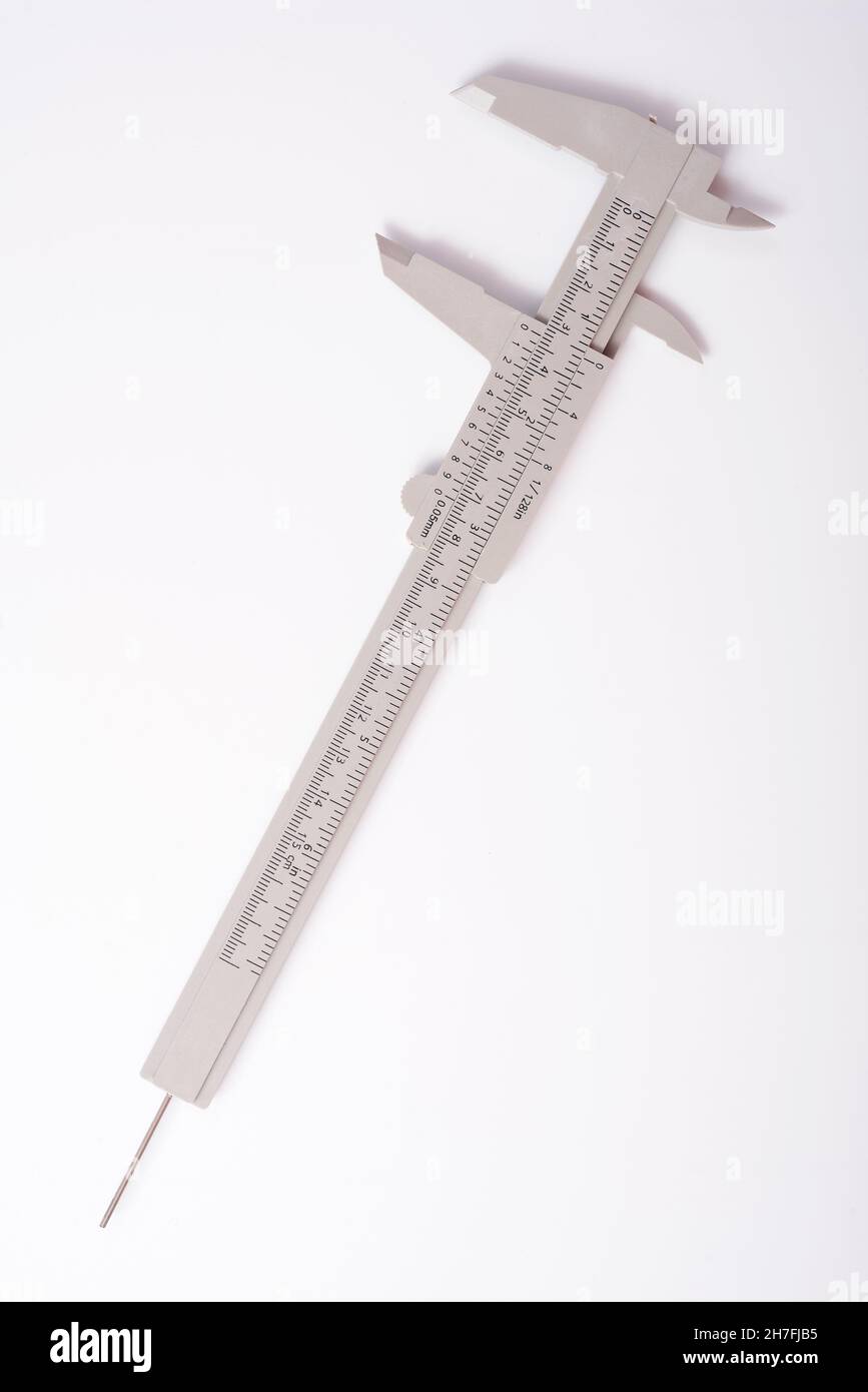Metal vernier caliper, vernier caliper is a measuring instrument used to precisely measure linear dimensions on white background Stock Photo