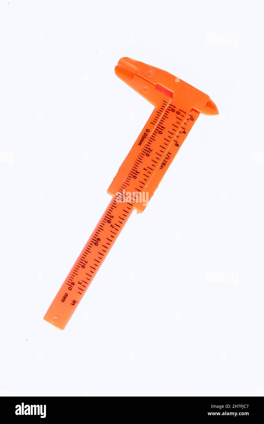 Orange vernier caliper plastic, vernier caliper is a measuring instrument used to precisely measure linear dimensions on white background Stock Photo