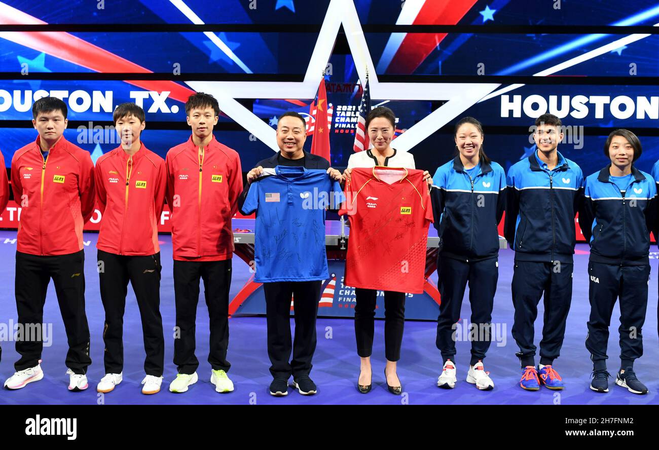 Houston, USA. 22nd Nov, 2021. Liu Guoliang (4th L), World Table Tennis Council Chair and president of the Chinese Table Tennis Association exchanges team jersy with Virginia Sung (4th R), Chief Executive Officer of USA Table Tennis during a joint training session of two pairs formed of both American and Chinese players entering the mixed doubles competition at the 2021 World Table Tennis Championships in Houston, the United States, on Nov. 22, 2021. Credit: Wu Xiaoling/Xinhua/Alamy Live News Stock Photo