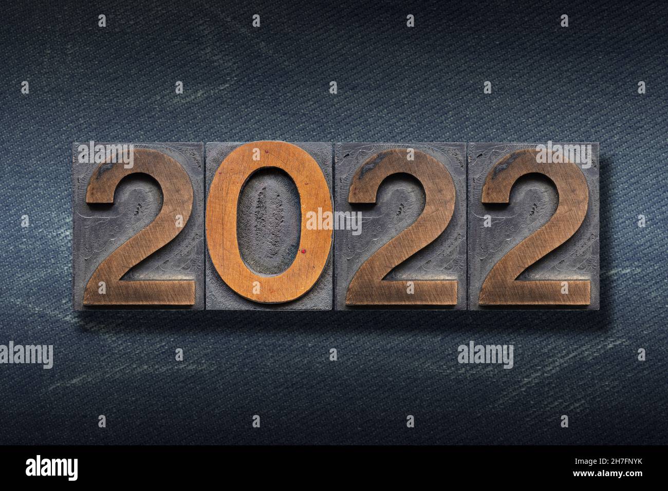 numbers 2022 made from wooden letterpress on dark jeans background Stock Photo