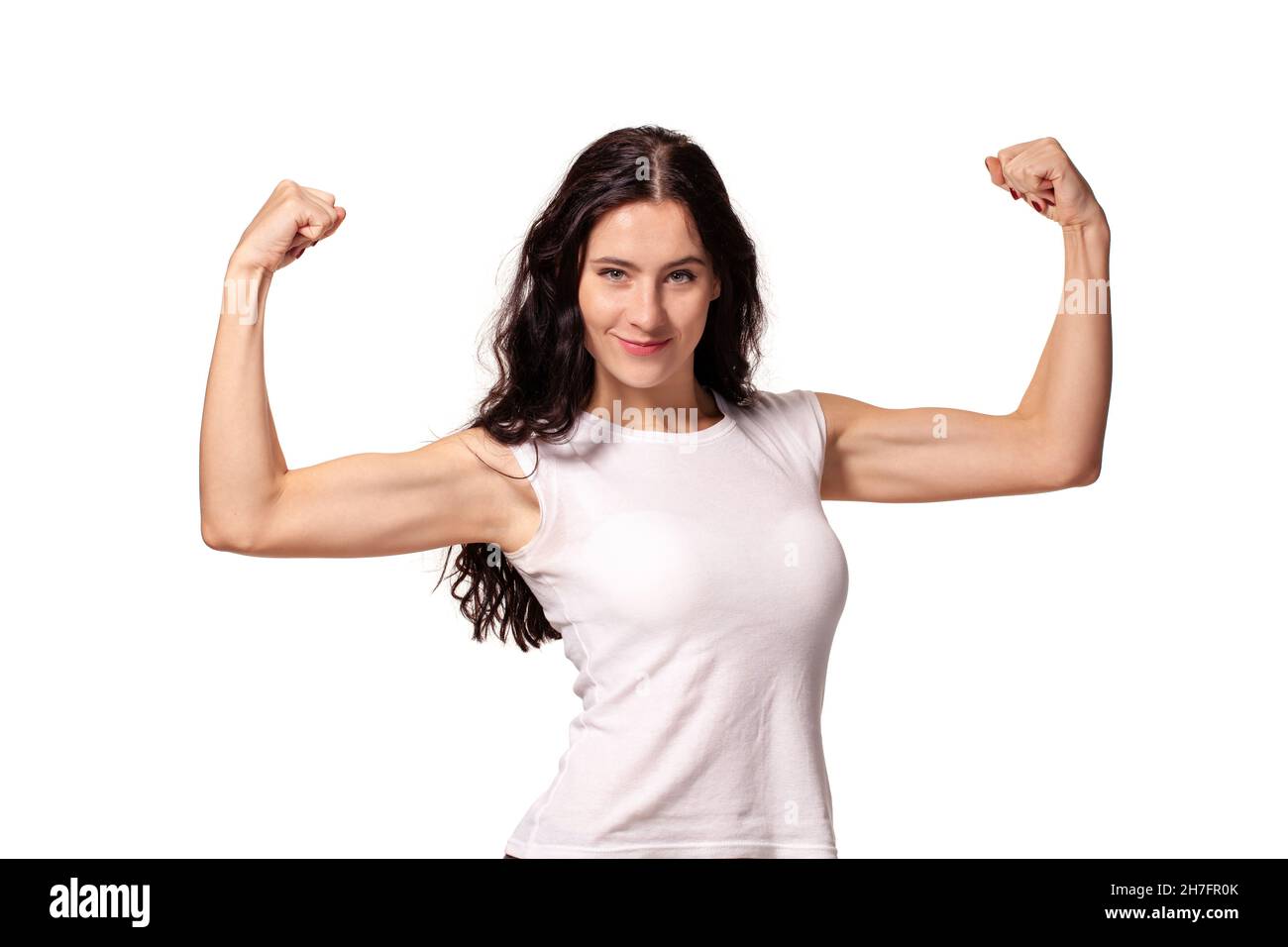 Happy young woman shows her muscles isolated on white background Stock Photo