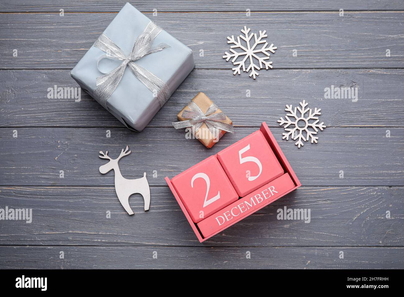 Calendar with date of Christmas, gift boxes and decorations on grey Date Of Christmas