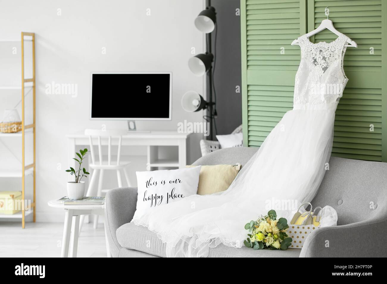 Wedding dress, shoes and bouquet prepared for ceremony in room Stock Photo