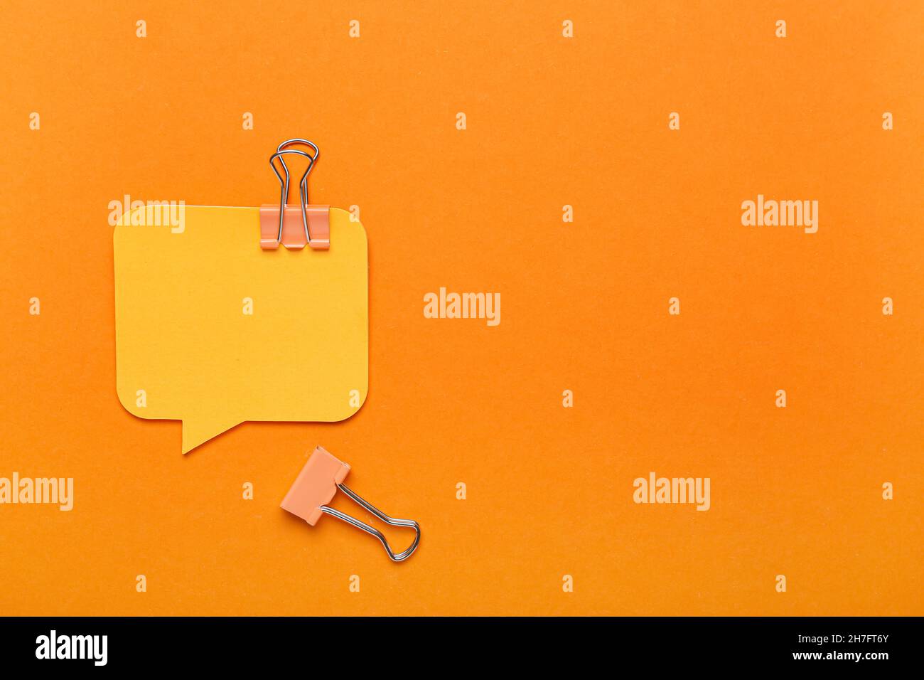 Sticky notes and binder clips on color background Stock Photo