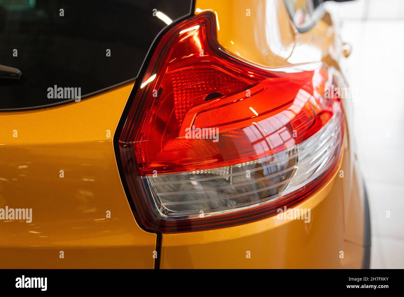 Closeup of rear light of orange Seat leon parked in the street Stock Photo