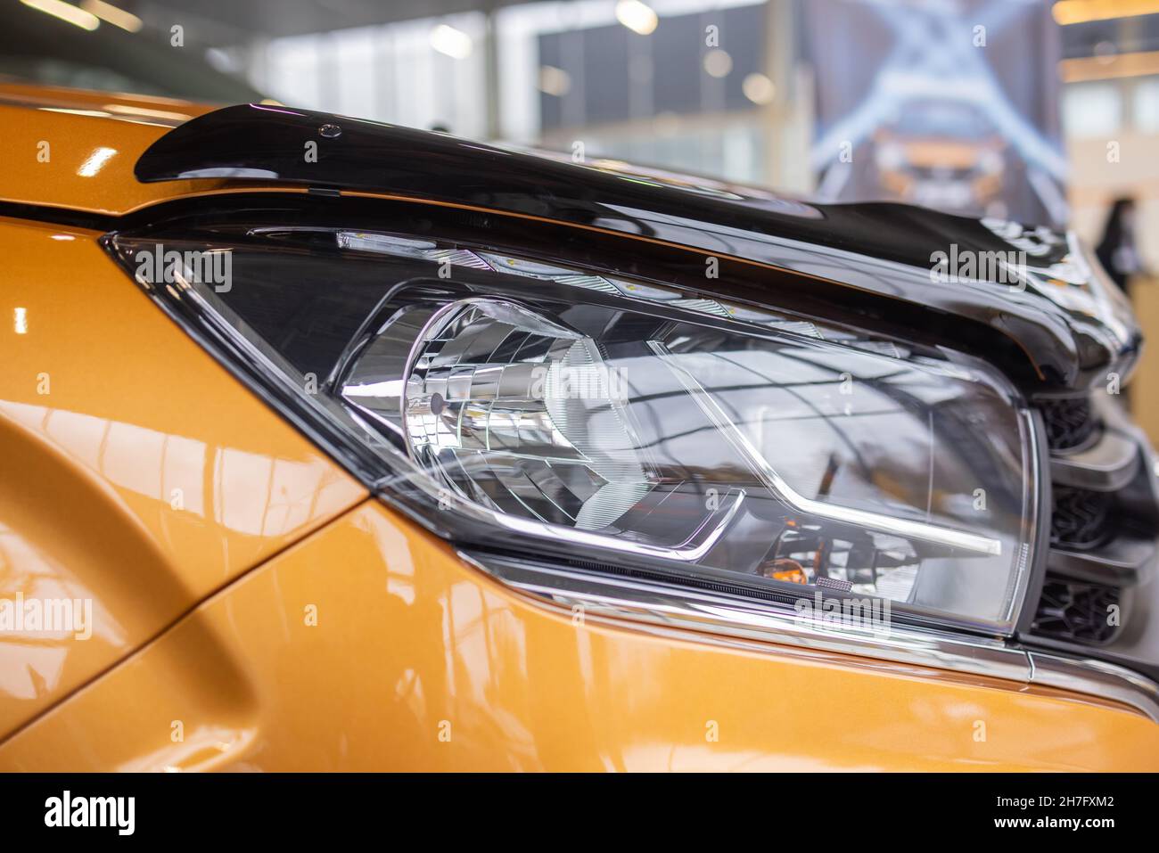 Orange car headlights. Exterior detail. Close up detail on one of the