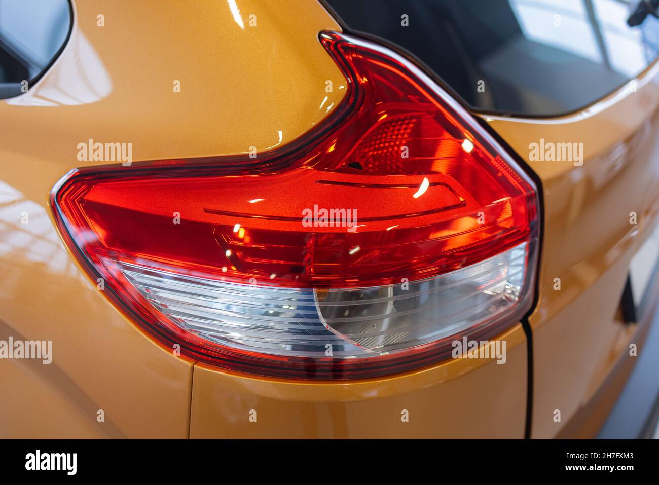 Closeup of rear light of orange Seat leon parked in the street Stock Photo