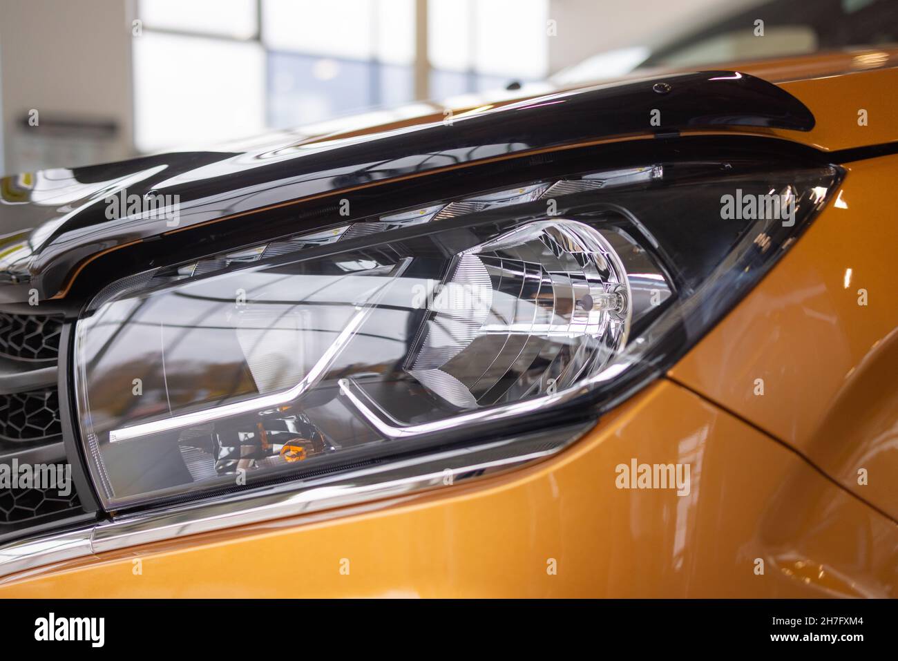 Orange car headlights. Exterior detail. Close up detail on one of the