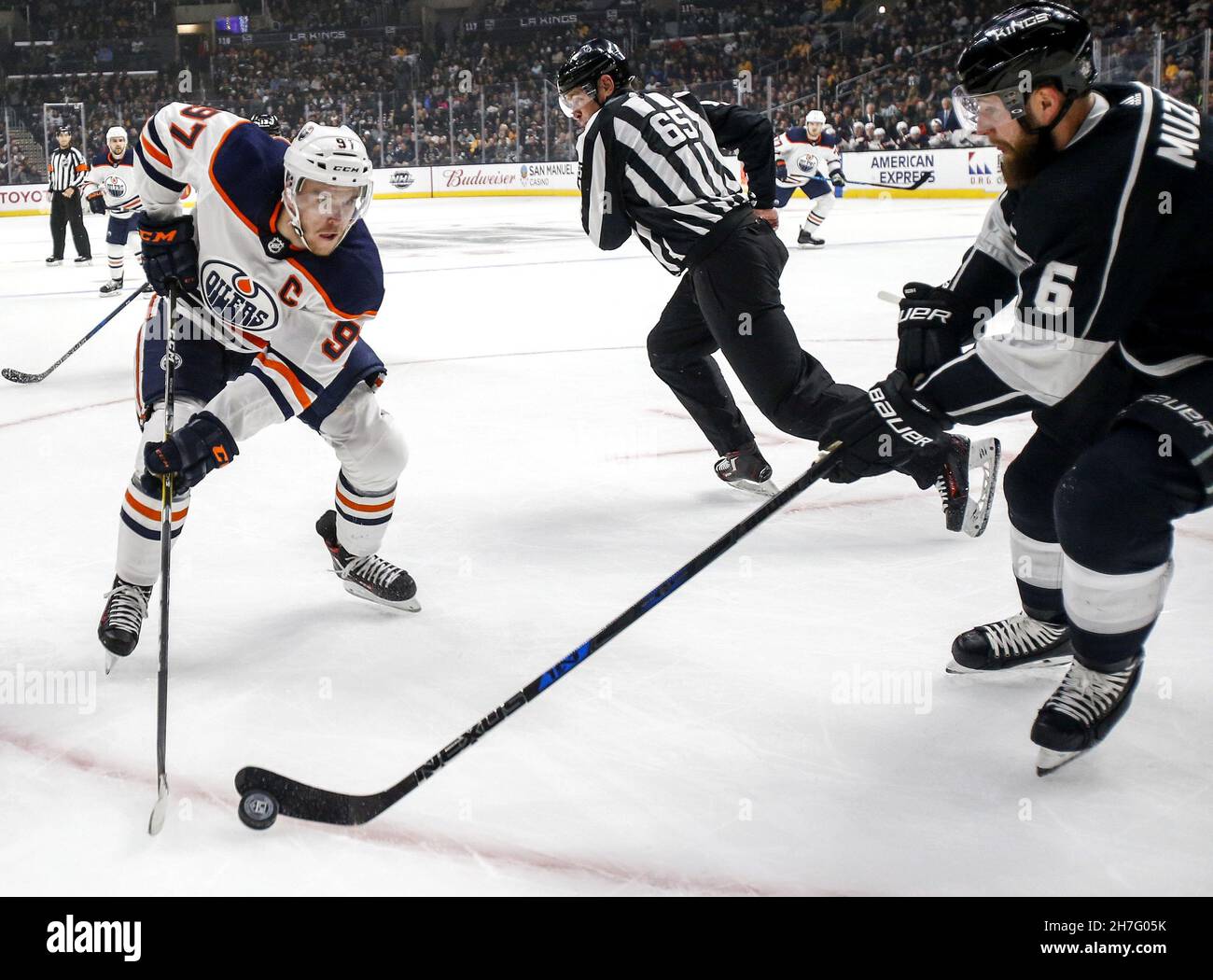 Beijing, USA. 24th Feb, 2018. Edmonton Oilers' Connor McDavid (L) vies with Los Angeles Kings' Jake Muzzin during a 2017-2018 NHL hockey game in Los Angeles, the United States, on Feb. 24, 2018. Credit: Zhao Hanrong/Xinhua/Alamy Live News Stock Photo