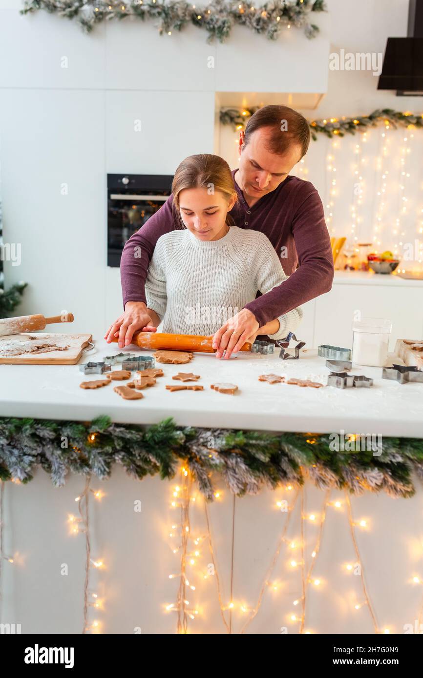 Father with daughter cooking making gingerbread, cutting cookies of ...