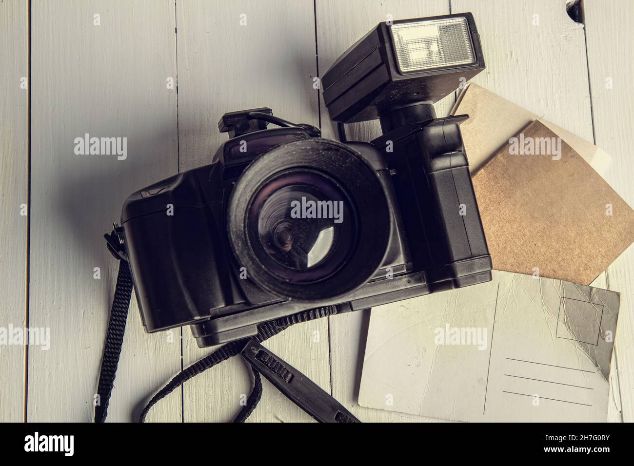Old film retro camera and several blank backgrounds on rough wooden table Stock Photo
