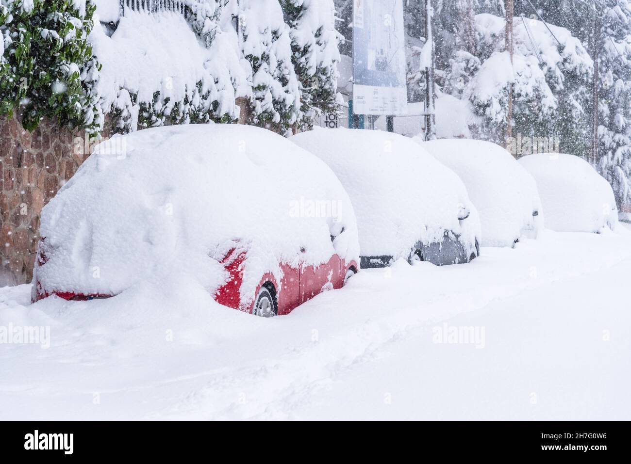 View of city street covered in snow during heavy snowfall with trapped ...