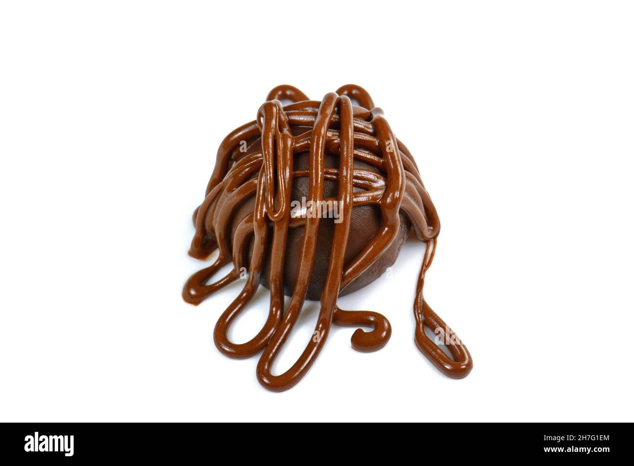 Chocolate truffle ball covered with melted chocolate isolated on white background Stock Photo