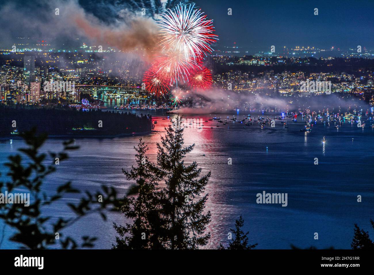 Beautiful shot of bright colorful exploding fireworks in a city over ...