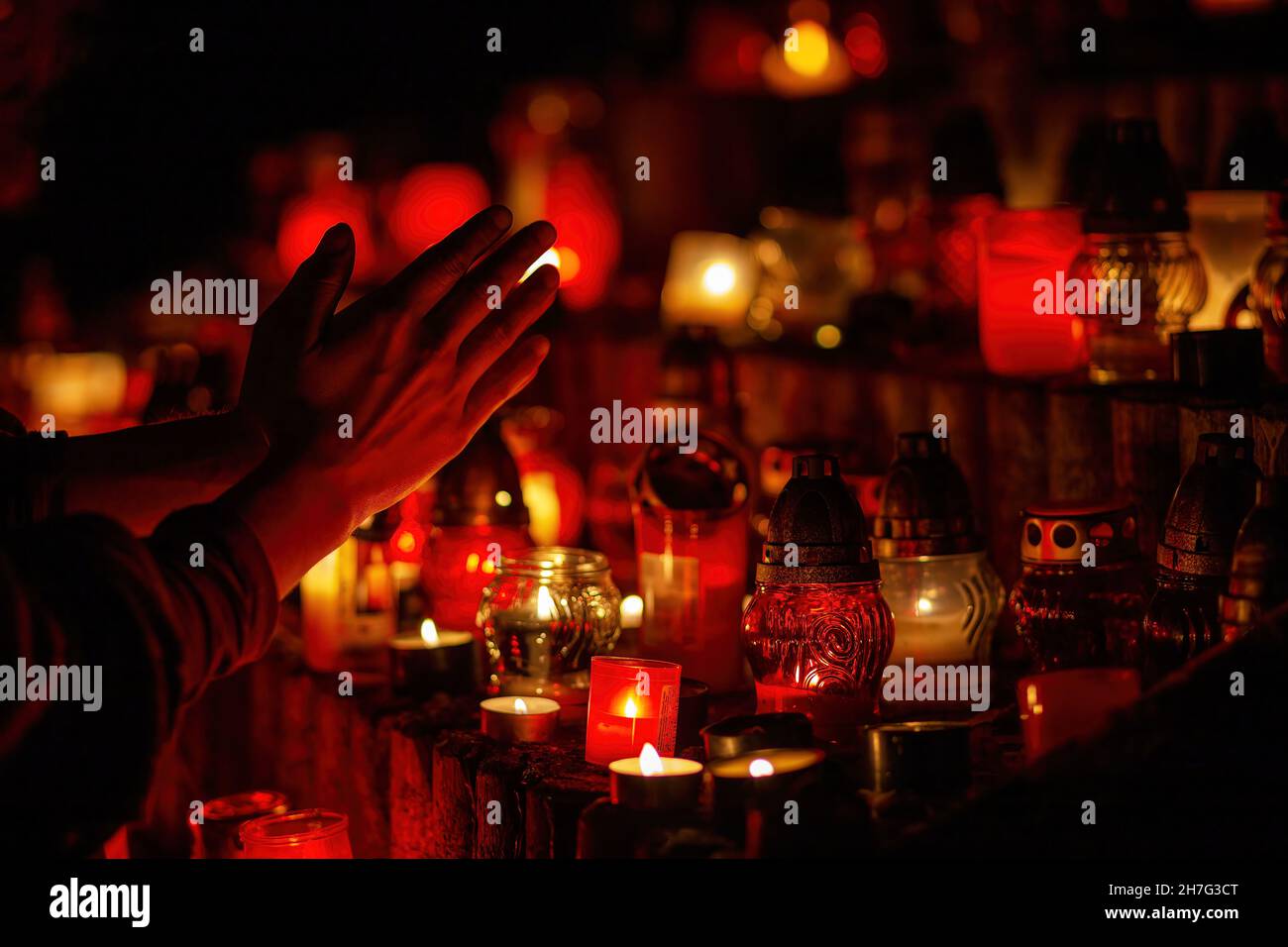 prayer hands. Candles in the cemetery. 1st November. Feast of All