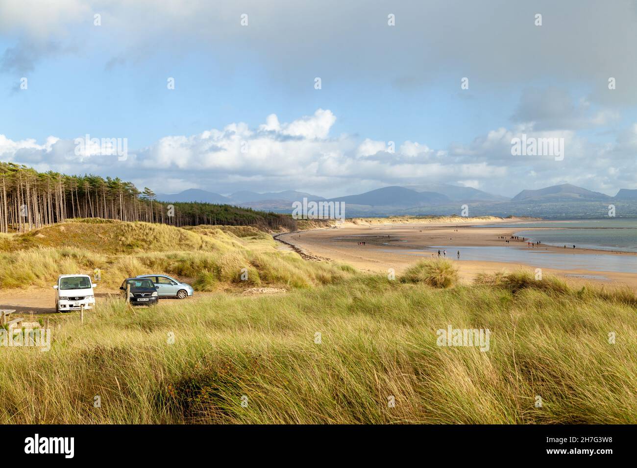 Cars parked at Newborough beach, Isle of Anglesey, Wales Stock Photo