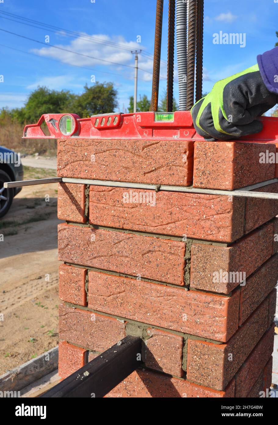 Brick fence pillar, column construction with steel rebars and vertical
