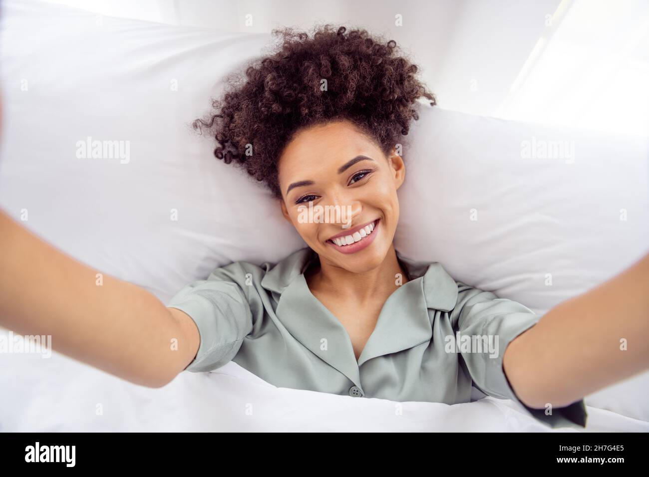 Self Portrait Of Attractive Cheerful Healthy Wavy Haired Girl Lying In
