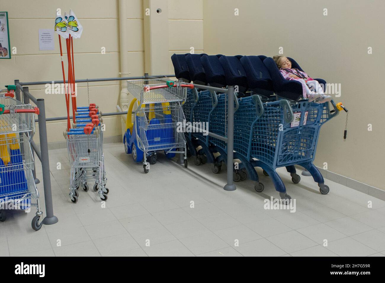 A lonely child among shopping carts. Stock Photo