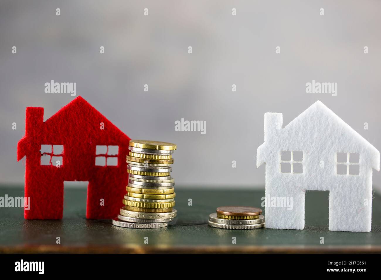 The choice between housing area. stack coins comparison of two offers, Property valuation Stock Photo
