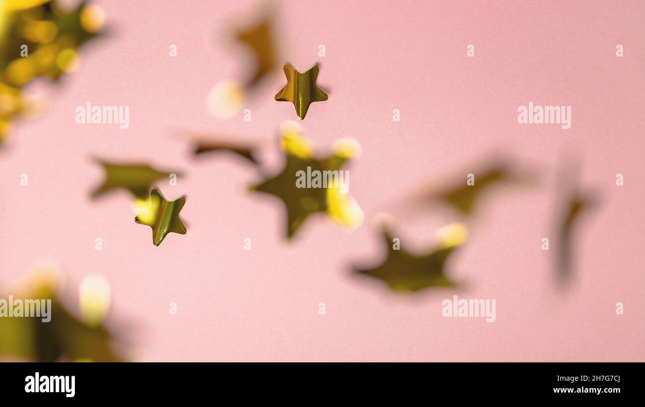 Background with flying gold confetti stars. Pink background. Wallpaper ...