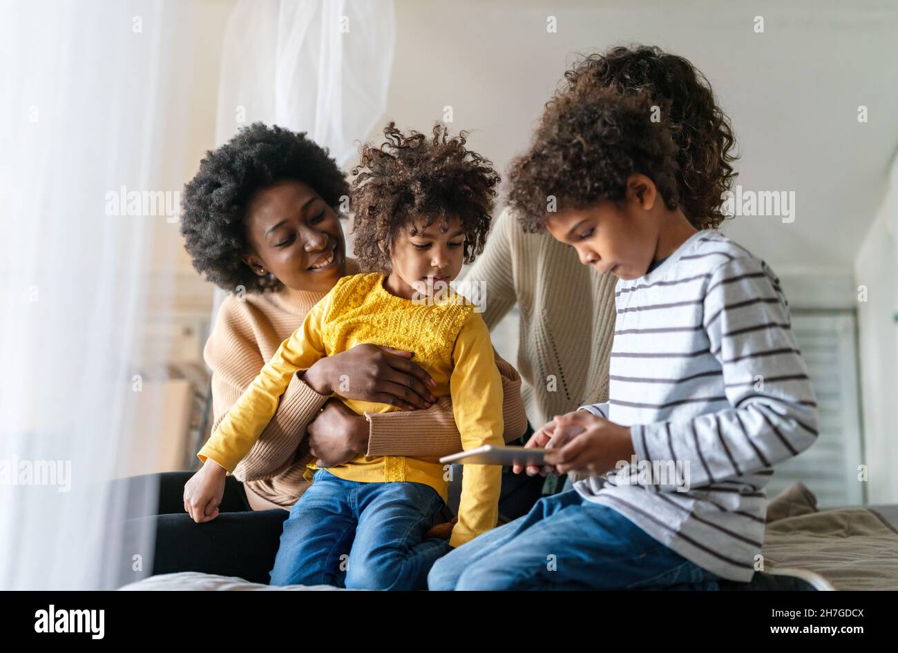 Gay couple children love happiness concept. Happy multiethnic family spending time together at home Stock Photo