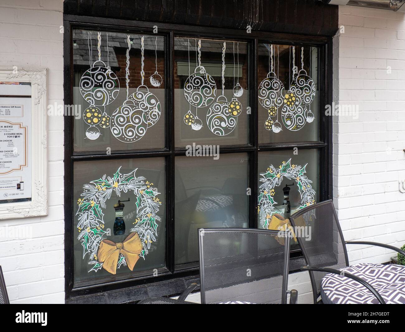 Exterior of Black Pepper, a Turkish restaurant in Buckingham, Buckinghamshire, UK; with Christmas decorations in the window Stock Photo