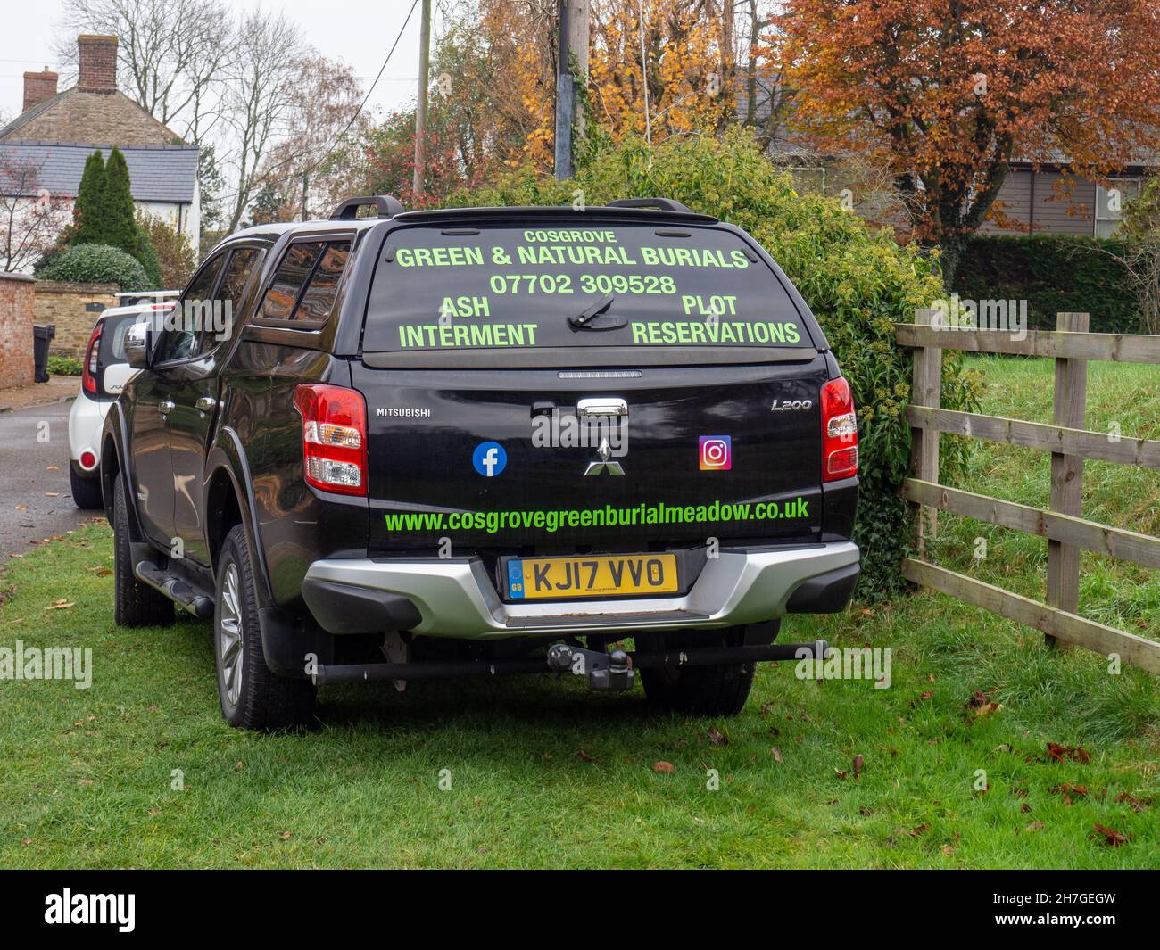 Mitsubishi vehicle with advertising for the Cosgrove Green Burial Meadow on the rear; Gayton village, Nortrhamptonshire, UK Stock Photo