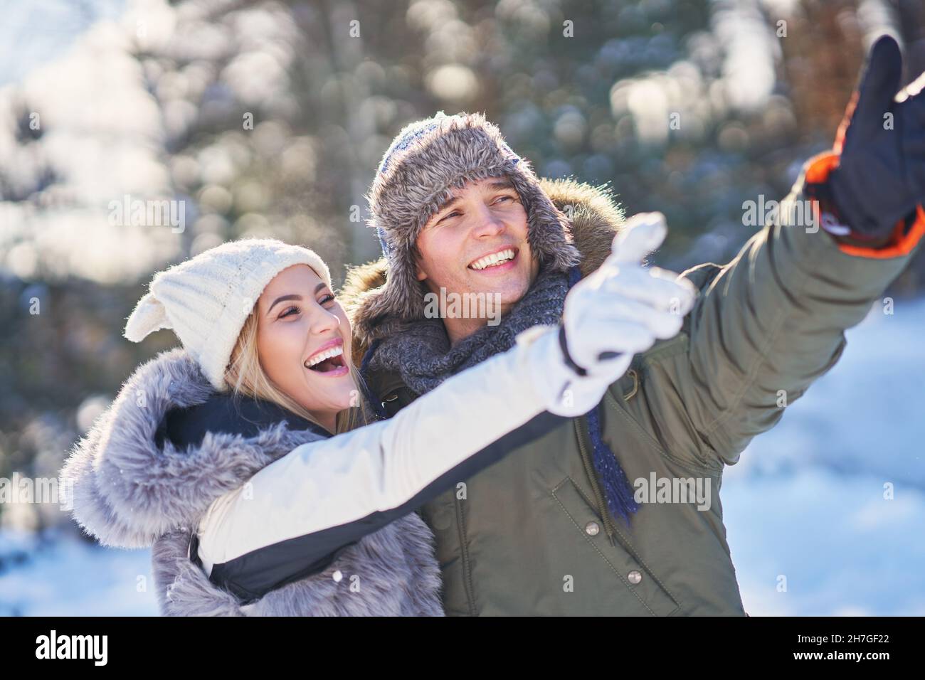 Couple having fun in winter scenery and snow Stock Photo - Alamy